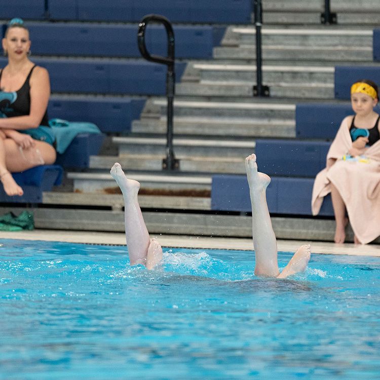 Girls finishing their artistic swimming routine in the pool